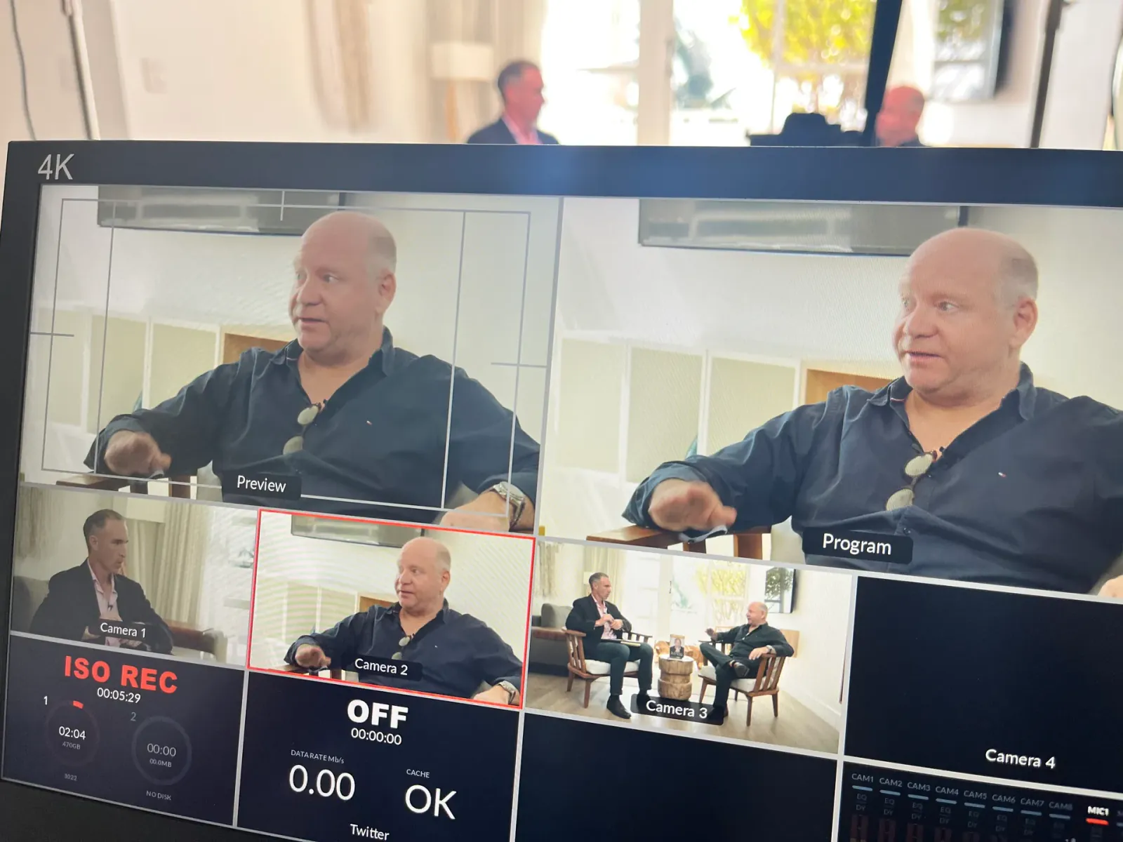 Multi-camera podcast recording session with 4K production monitor and live switching